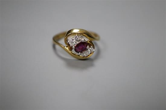 A modern 18ct gold, single stone ruby and four stone diamond set crossover ring, size L, gross 3.5 grams.